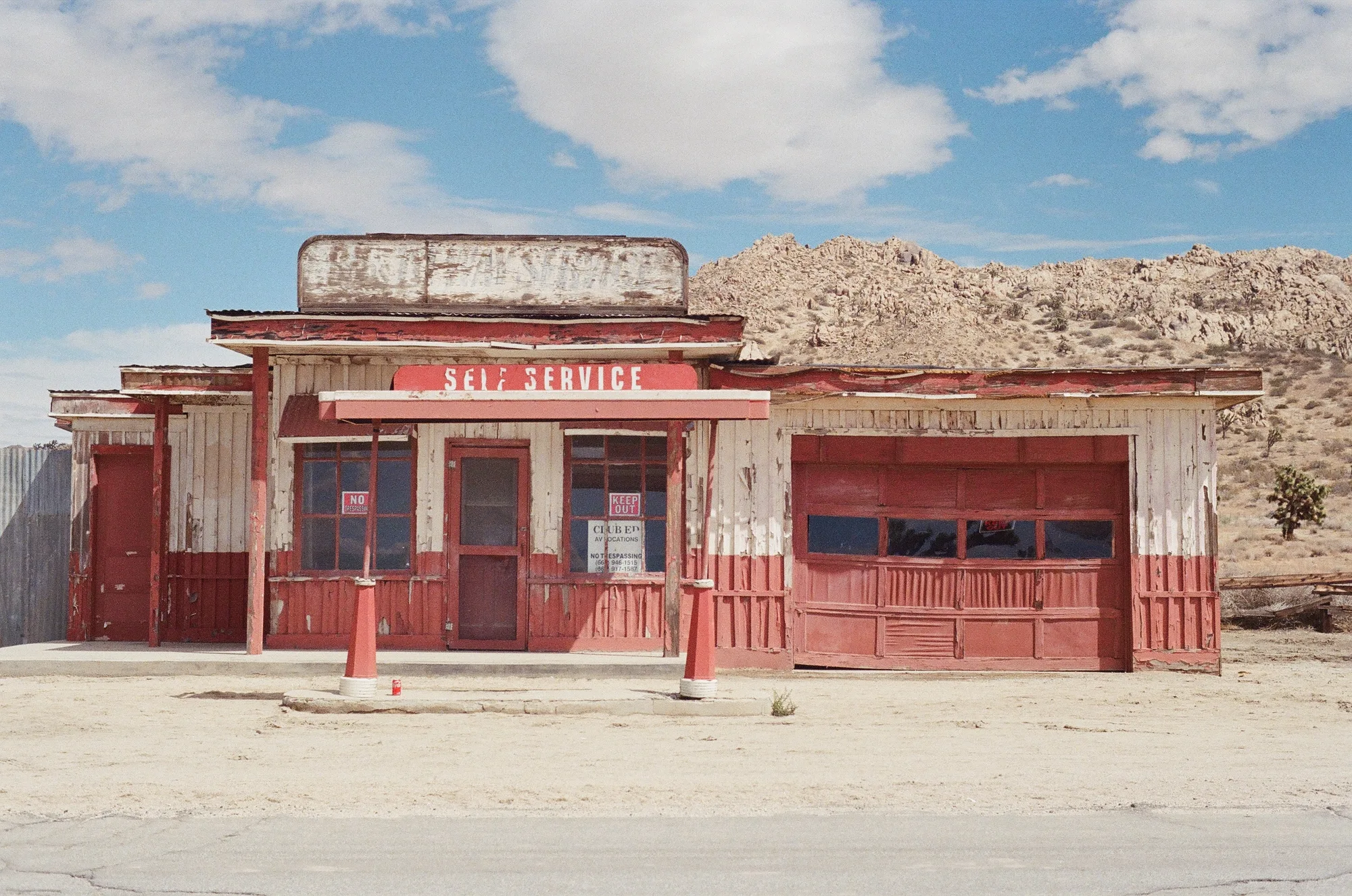 An old service station contrasted against the desert background.